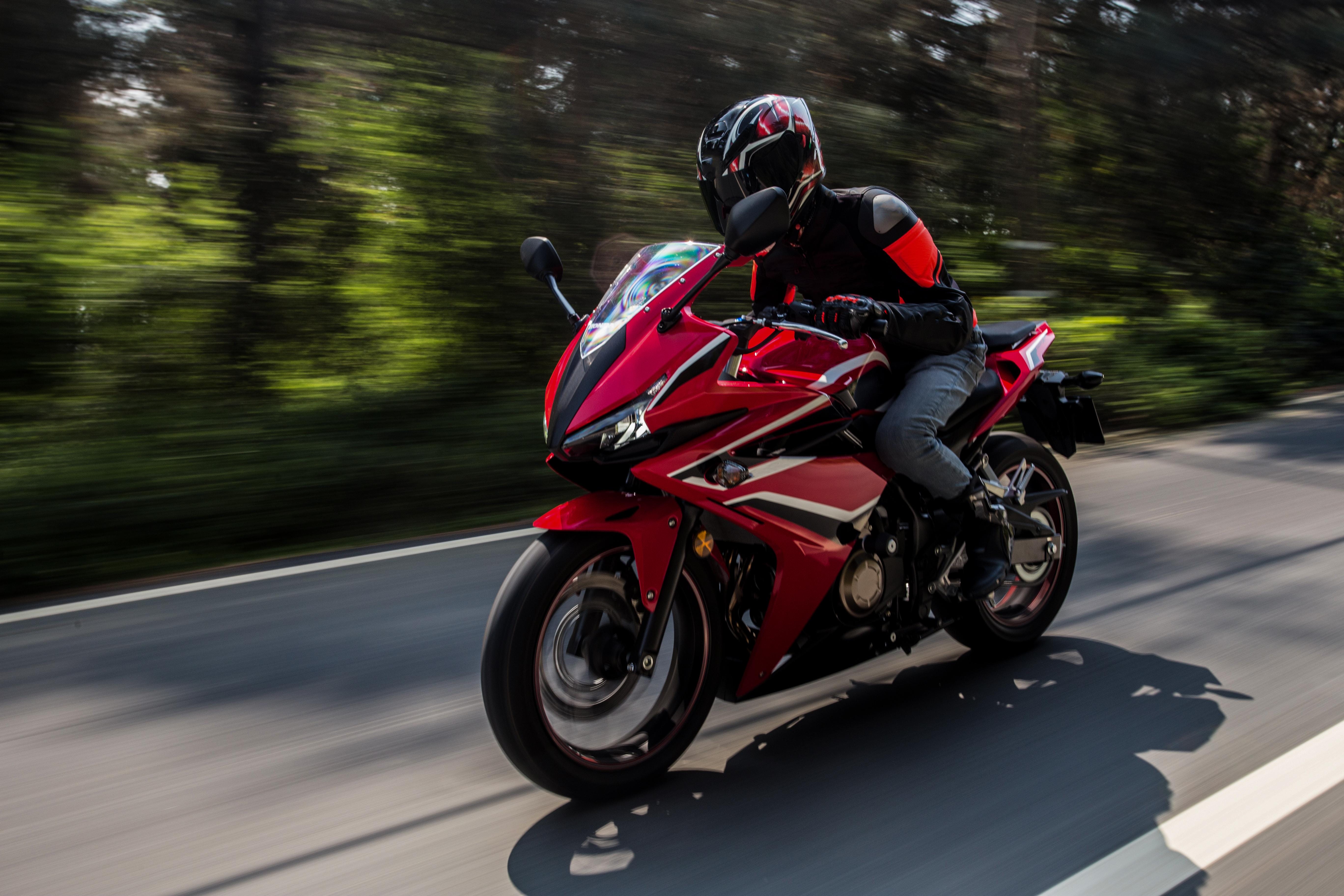 A motorcycle rider smiling after a long ride